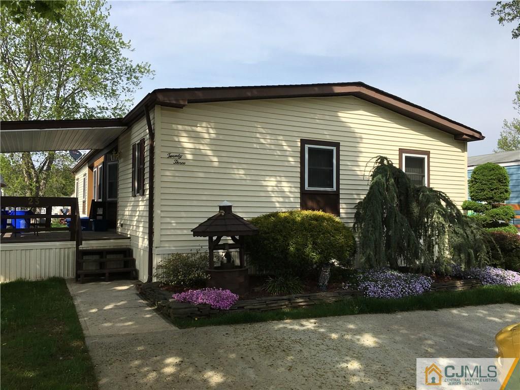 a view of house with backyard and garden