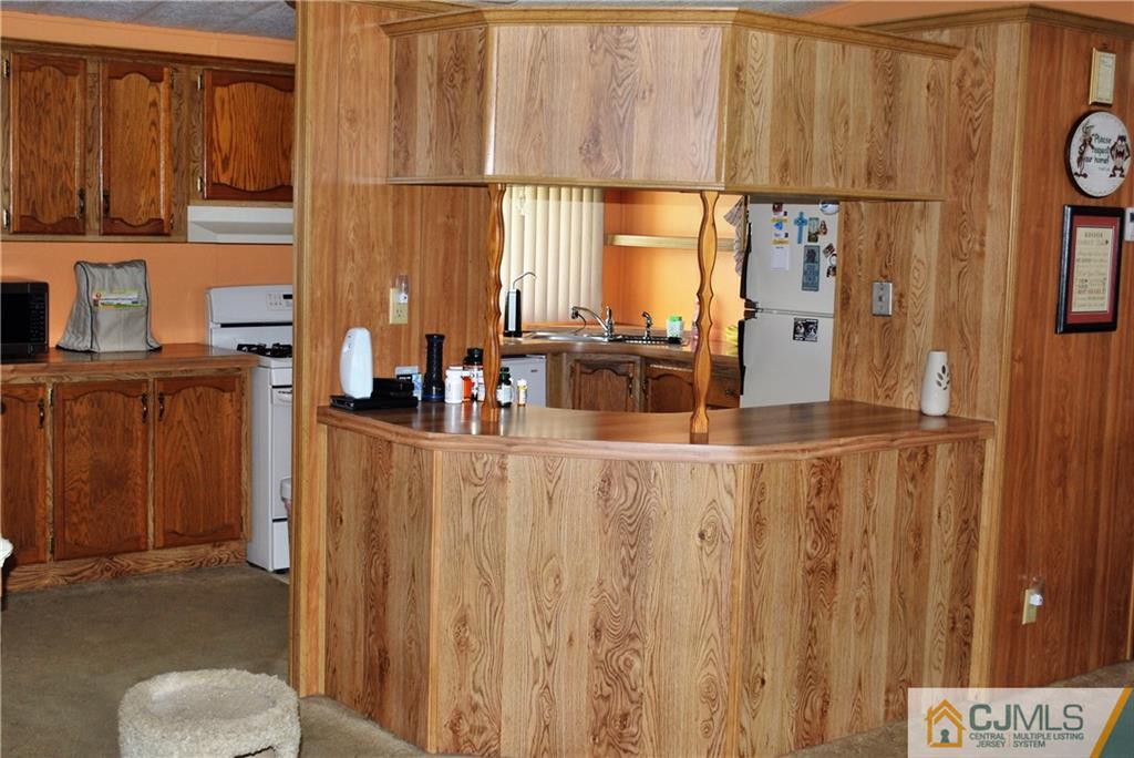 23 Poe Road, Unit 23 North Brunswick, NJ 08902 - Photo 14 of 16 a view of kitchen with furniture and large window