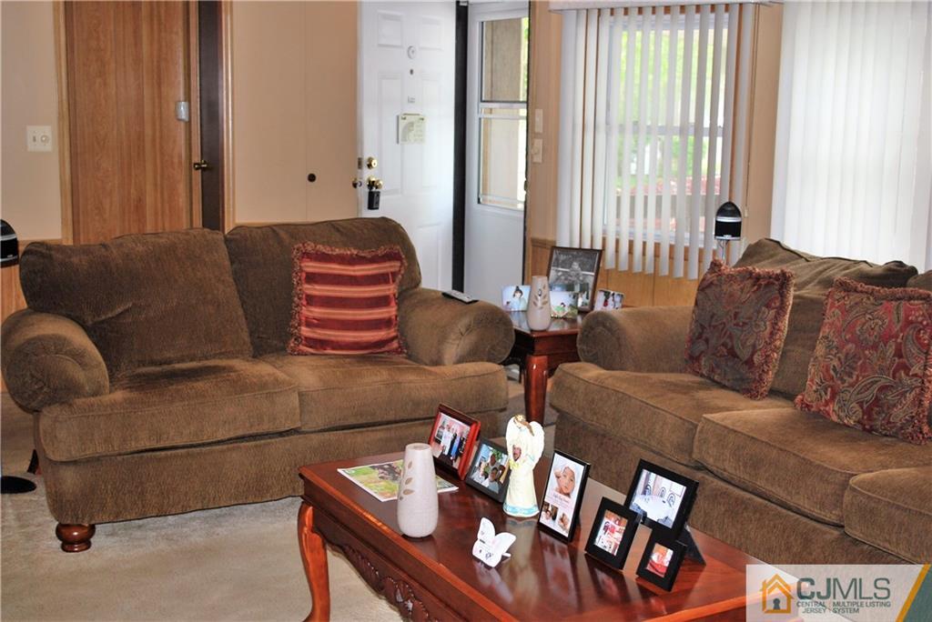 23 Poe Road, Unit 23 North Brunswick, NJ 08902 - Photo 10 of 16 a living room with furniture and a large window