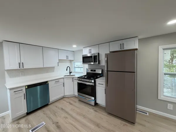 a kitchen with a refrigerator sink and stove