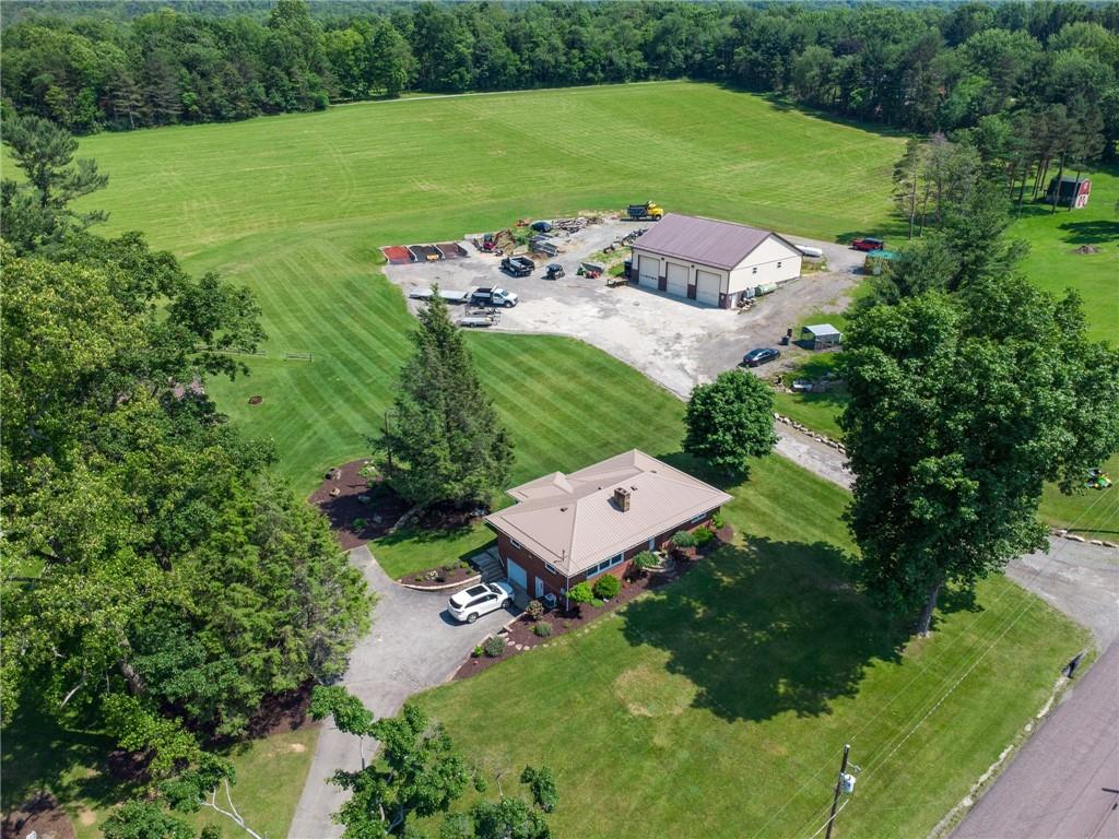 an aerial view of a house with a yard