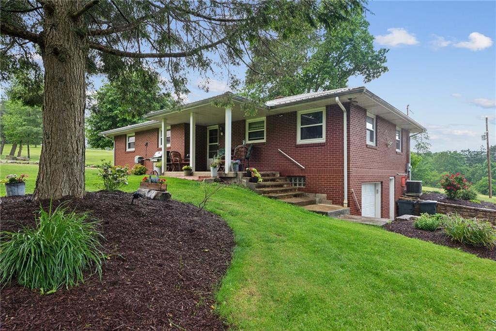 234 Ankney Hl Road Acme, PA 15610 - Photo 20 of 47 a front view of house with yard and green space