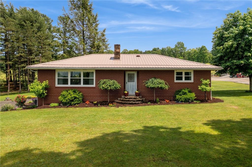 234 Ankney Hl Road Acme, PA 15610 - Photo 2 of 47 a view of a house with backyard sitting area and garden
