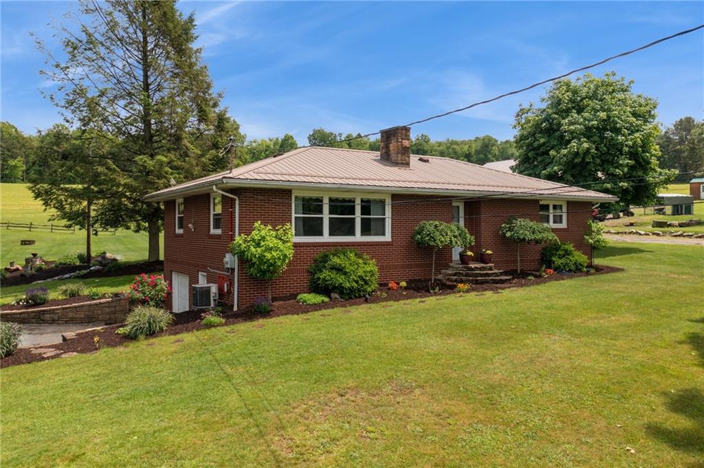 234 Ankney Hl Road Acme, PA 15610 - Photo 5 of 47 a view of a house with backyard sitting area and garden