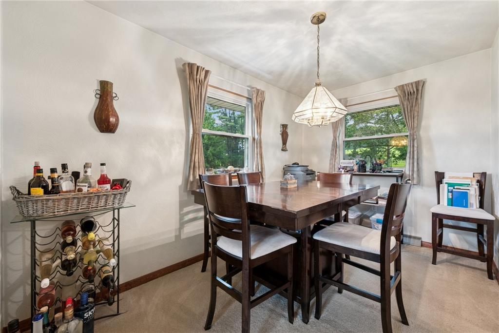 234 Ankney Hl Road Acme, PA 15610 - Photo 9 of 47 a dining room with wooden floor a chandelier a wooden table and chairs