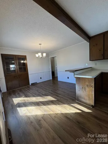 a view of a room with wooden floor