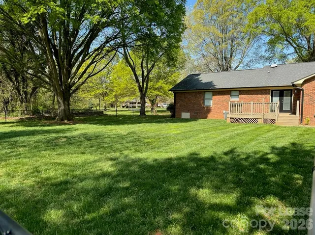 a view of a living room with furniture and a chandelier