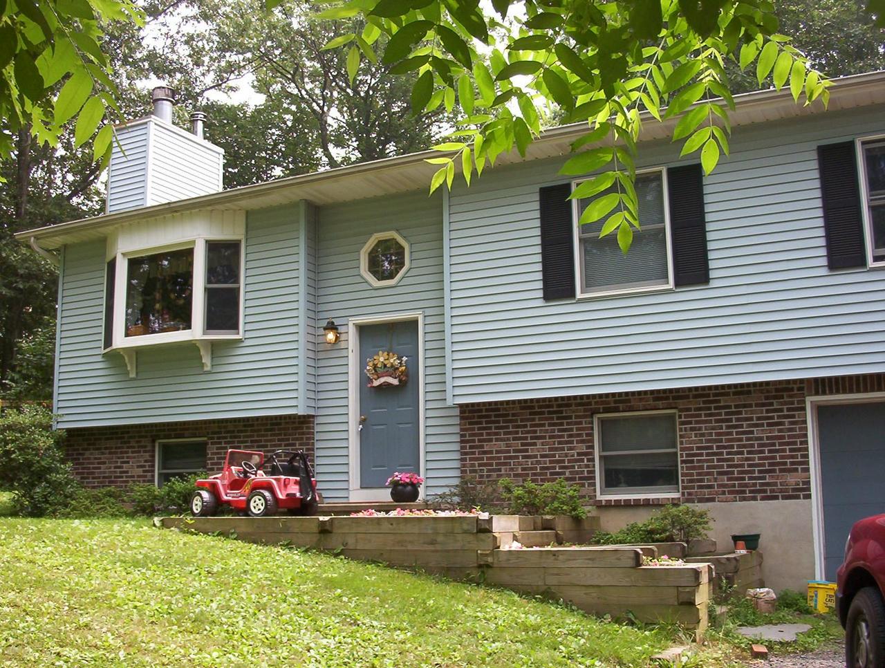 Lot 3 Laurel Ridge Road East Stroudsburg, PA 18302 - Photo 1 of 11 a front view of a house with a yard and a garage