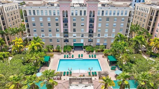 a view of a tall building next to a yard