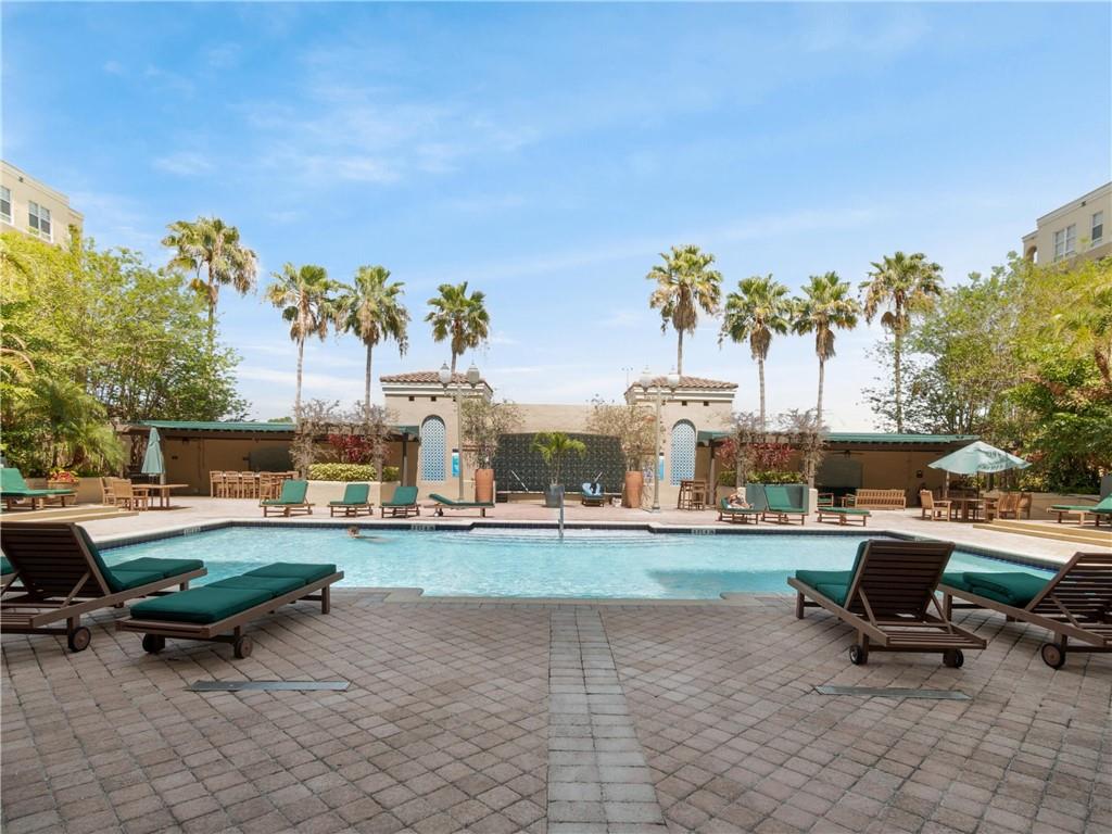520 Southeast 5th Avenue, Unit 1502 Fort Lauderdale, FL 33301 - Photo 2 of 17 a view of a backyard with table and chairs under an umbrella