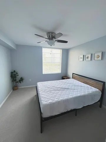 a bedroom with a bed and window
