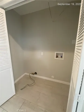 a view of a room with rack on the wall and shower