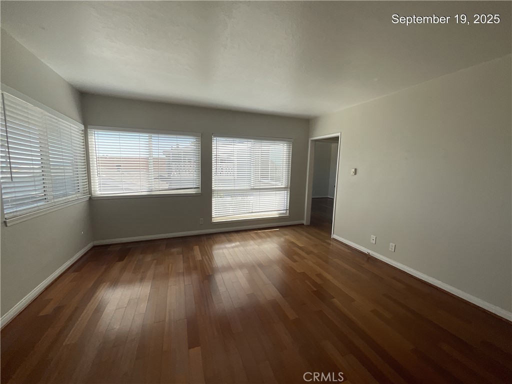 34021 Granada Drive, Unit B Dana Point, CA 92629 - Photo 15 of 23 an empty room with wooden floor and windows