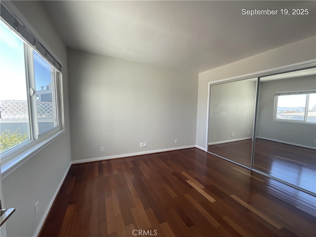 34021 Granada Drive, Unit B Dana Point, CA 92629 - Photo 16 of 23 a view of an empty room with wooden floor and a window