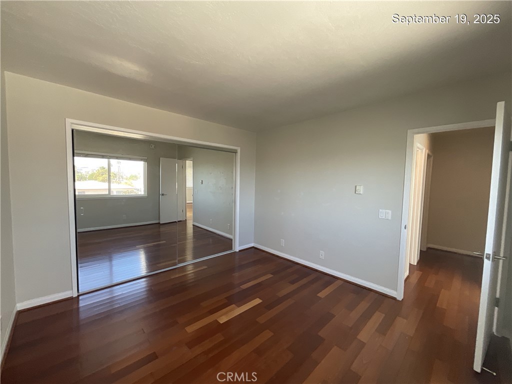 34021 Granada Drive, Unit B Dana Point, CA 92629 - Photo 17 of 23 an empty room with wooden floor and windows