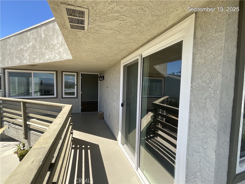 34021 Granada Drive, Unit B Dana Point, CA 92629 - Photo 2 of 23 a view of a balcony with furniture and wooden floor