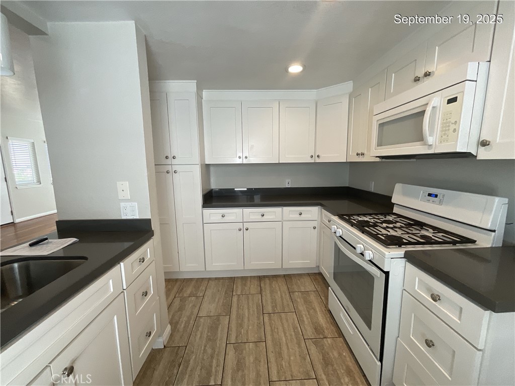 34021 Granada Drive, Unit B Dana Point, CA 92629 - Photo 4 of 23 a kitchen with granite countertop white cabinets stove and sink