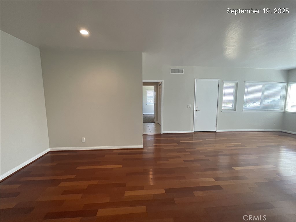 34021 Granada Drive, Unit B Dana Point, CA 92629 - Photo 5 of 23 a view of an empty room with wooden floor and windows