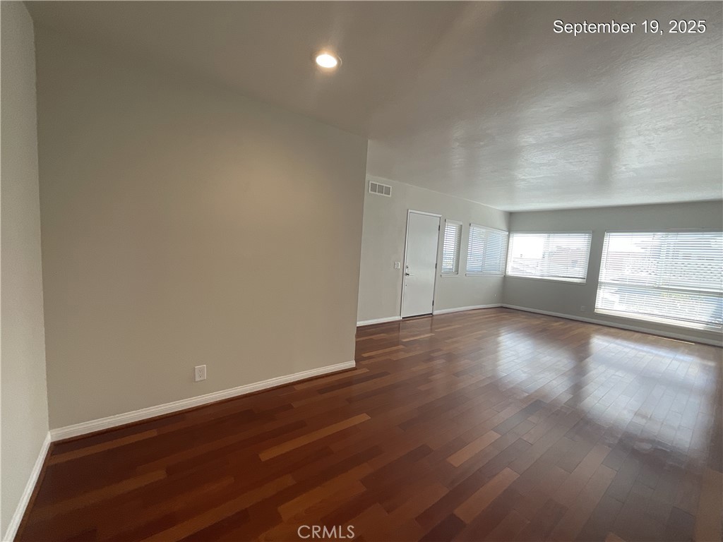 34021 Granada Drive, Unit B Dana Point, CA 92629 - Photo 6 of 23 an empty room with wooden floor and windows