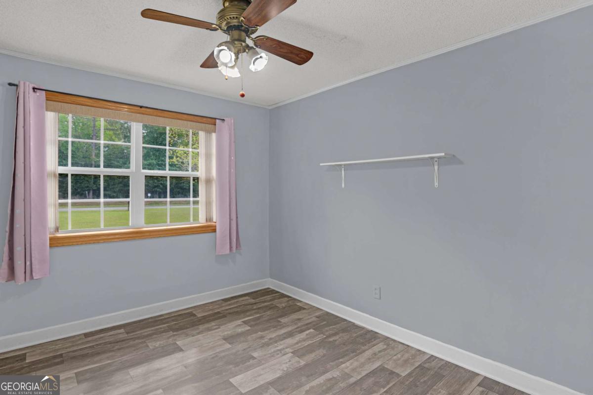 5837 Youmans Chapel Road Blackshear, GA 31516 - Photo 16 of 30 a view of empty room with ceiling fan