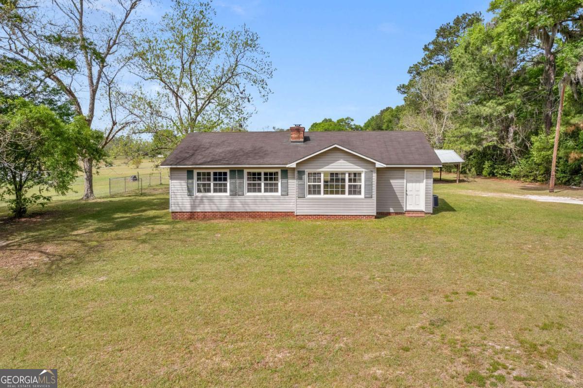 5837 Youmans Chapel Road Blackshear, GA 31516 - Photo 2 of 30 a front view of a house with swimming pool
