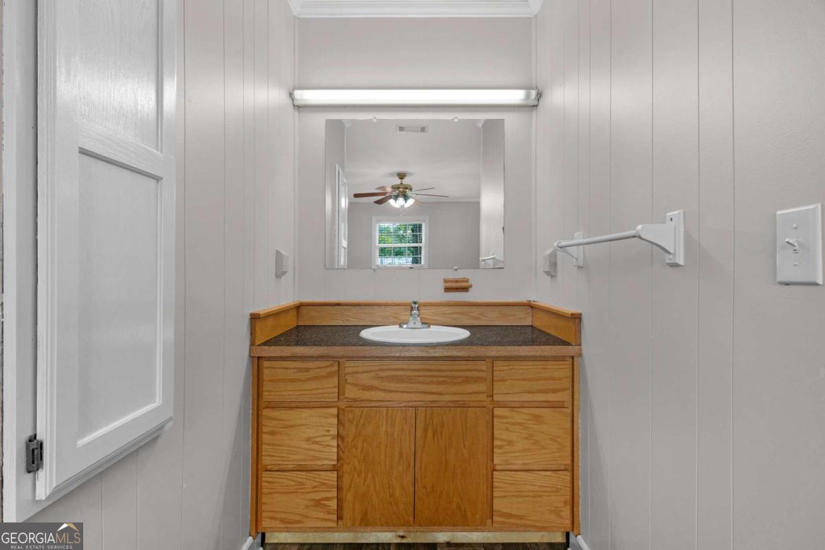 5837 Youmans Chapel Road Blackshear, GA 31516 - Photo 24 of 30 a bathroom with a sink and a mirror