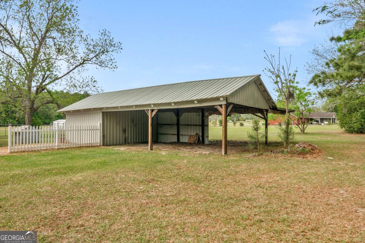 5837 Youmans Chapel Road Blackshear, GA 31516 - Photo 28 of 30 a house with yard in front of it