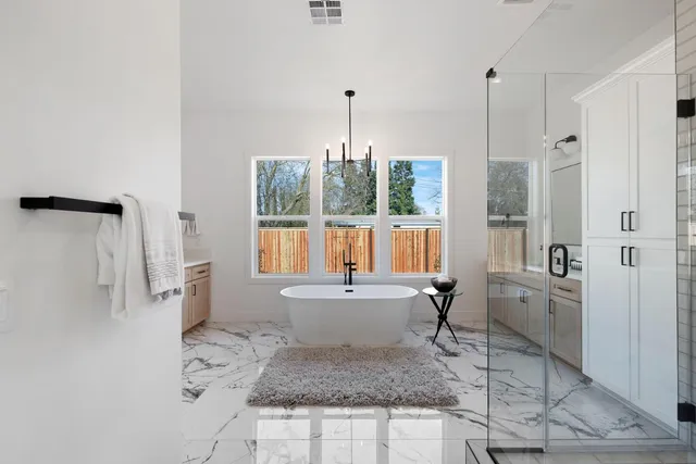 a view of a hallway with a dining table & chairs