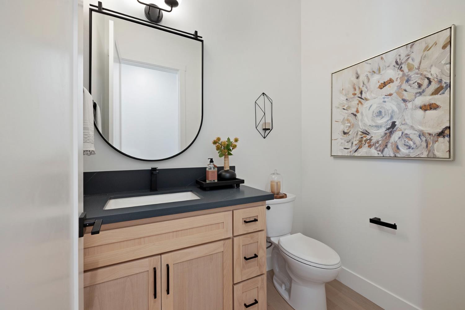 1510 Mission Avenue Carmichael, CA 95608 - Photo 42 of 60 a bathroom with a toilet a sink and a mirror