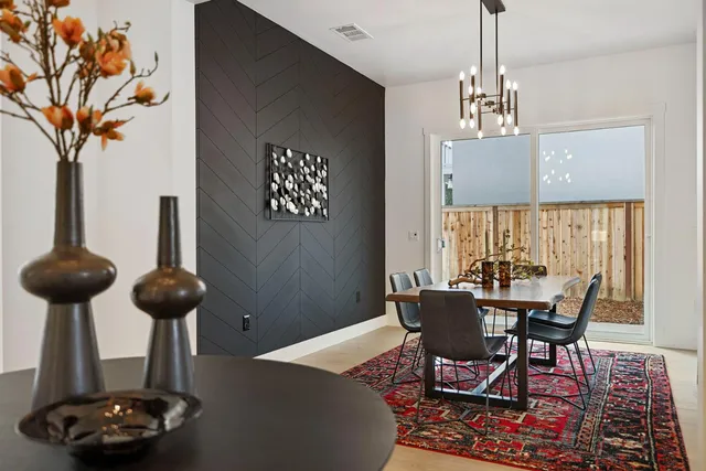 a view of a dining room with furniture and chandelier