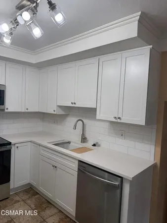 a kitchen with a sink cabinets and window