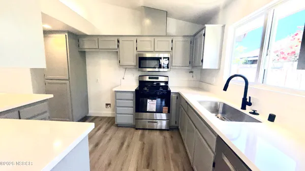 a kitchen with a refrigerator and a sink