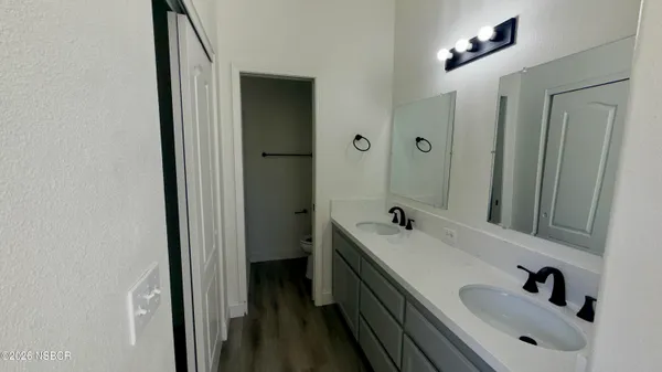 a bathroom with 2 sink and a mirror