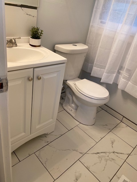 3420 Winnetka Road Glenview, IL 60026 - Photo 10 of 26 a white toilet sitting next to a bathroom sink