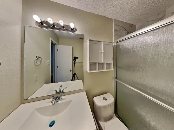 a bathroom with a toilet sink and shower