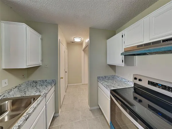 a kitchen with a sink stove and cabinets