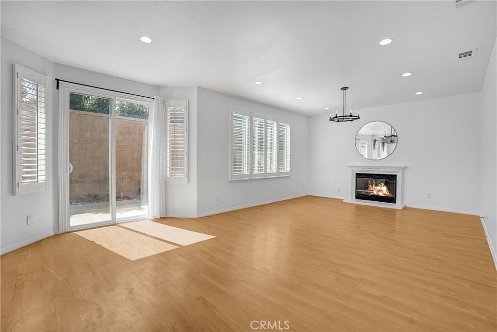 76 Millbrook Irvine, CA 92618 - Photo 15 of 51 a view of an empty room with a fireplace and a window