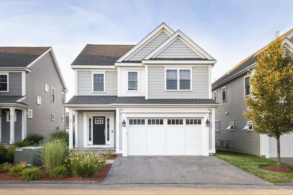 25 Oxbow Road, Unit 25 Framingham, MA 01701 - Photo 2 of 34 a front view of a house with a yard and garage