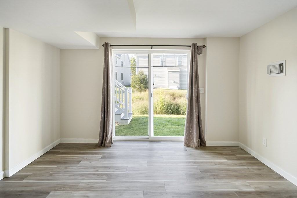 25 Oxbow Road, Unit 25 Framingham, MA 01701 - Photo 21 of 34 a view of a room with wooden floor and a window