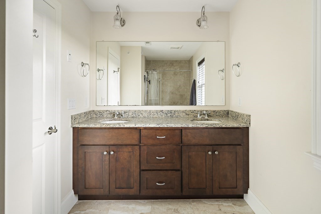 25 Oxbow Road, Unit 25 Framingham, MA 01701 - Photo 24 of 34 a bathroom with a granite countertop sink and a mirror