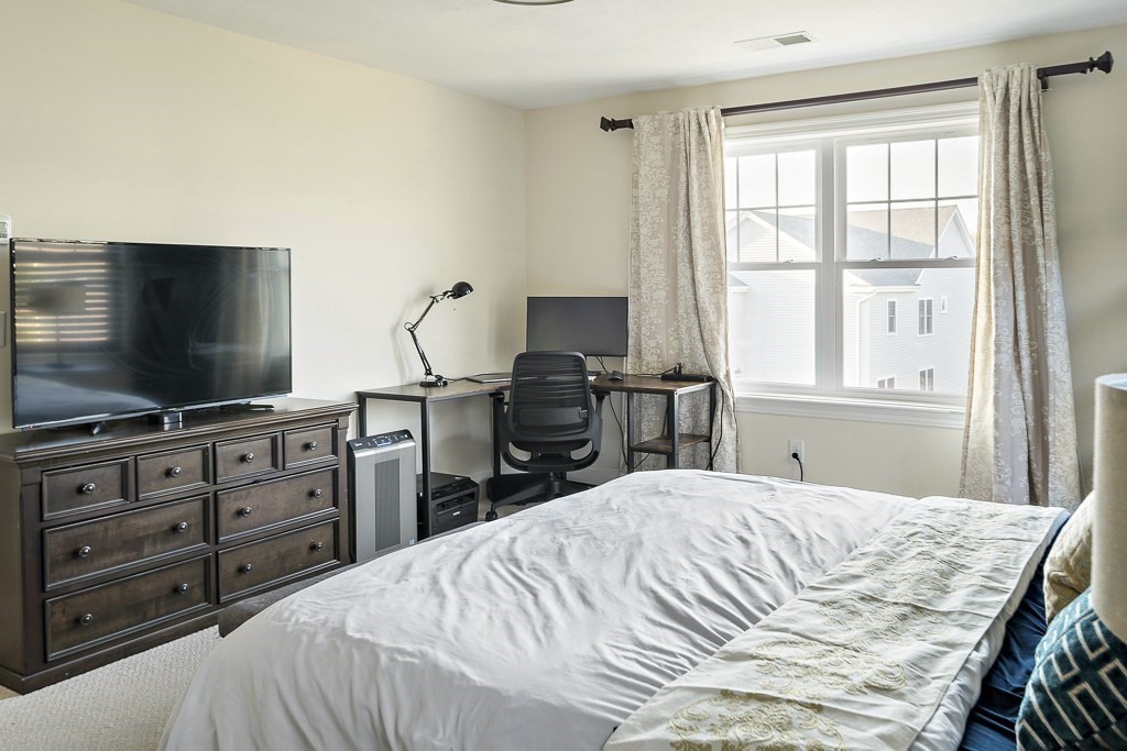 25 Oxbow Road, Unit 25 Framingham, MA 01701 - Photo 27 of 34 a bedroom with a bed and a flat screen tv