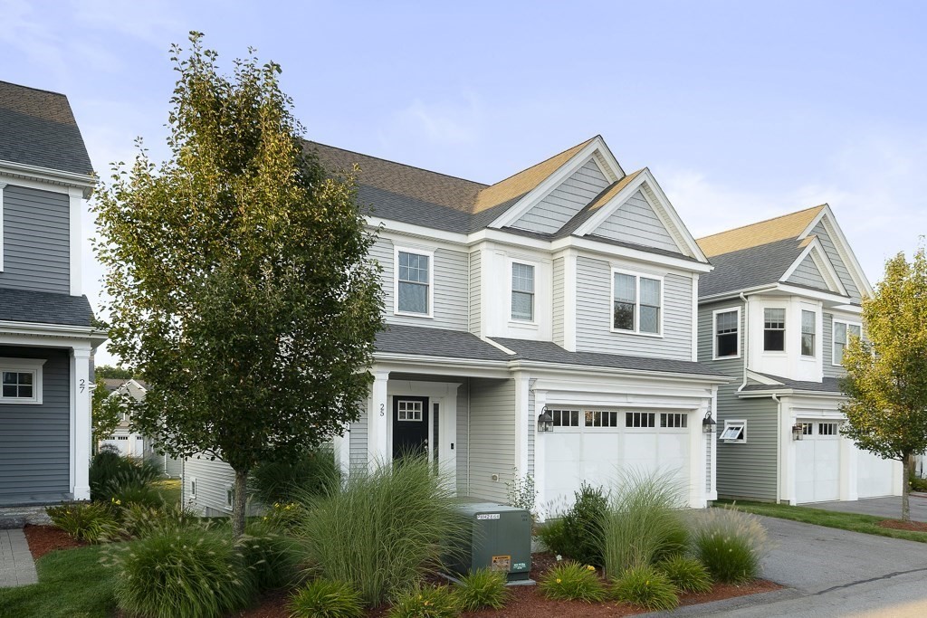 25 Oxbow Road, Unit 25 Framingham, MA 01701 - Photo 3 of 34 a front view of a house with a yard and trees