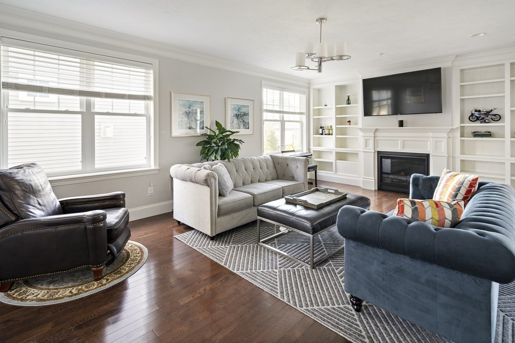 25 Oxbow Road, Unit 25 Framingham, MA 01701 - Photo 5 of 34 a living room with furniture a flat screen tv and a fireplace