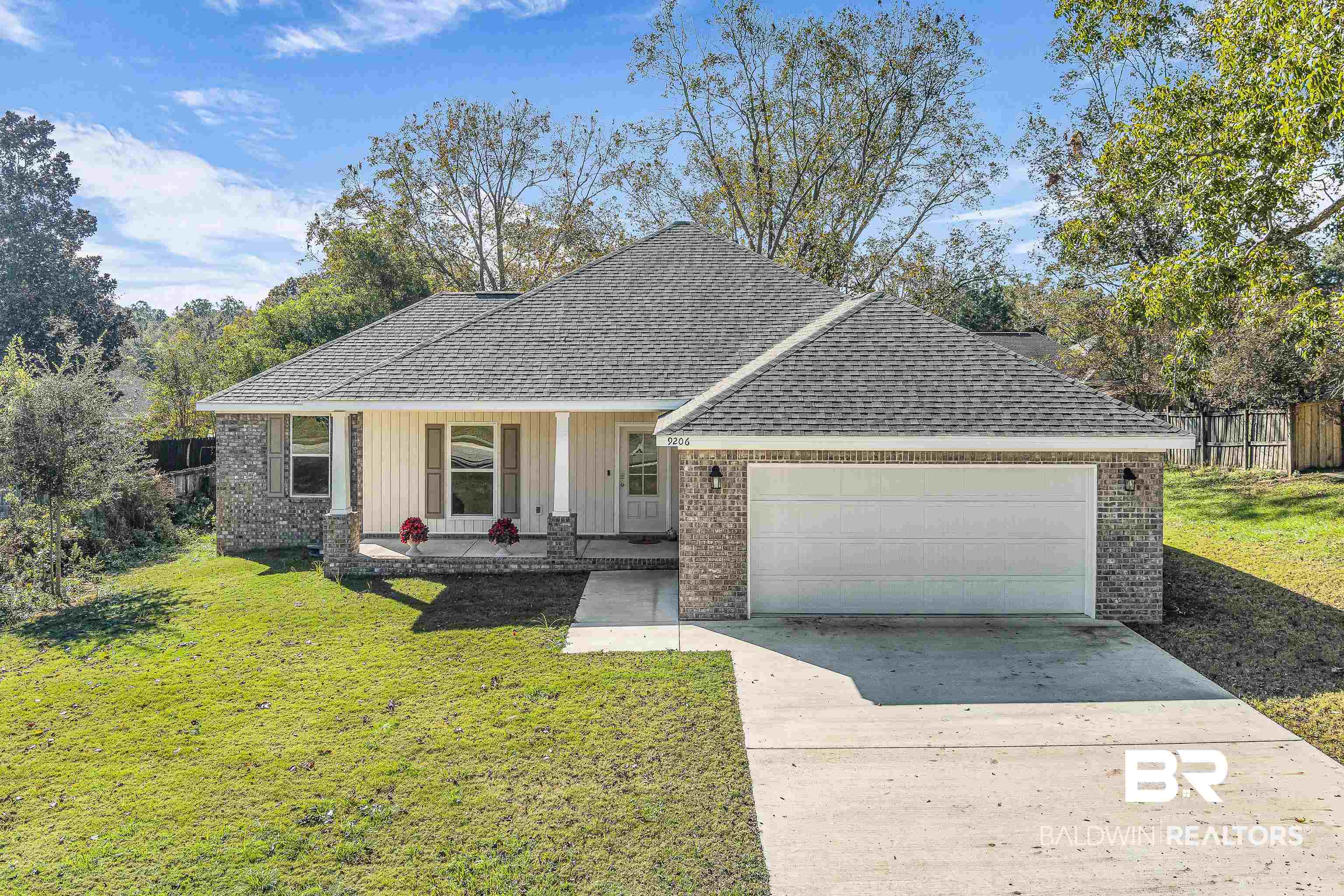 9206 Greenleaf Drive Daphne, AL 36527 - Photo 1 of 32 View of front of home with brick siding, a porch, roof with shingles, and concrete driveway