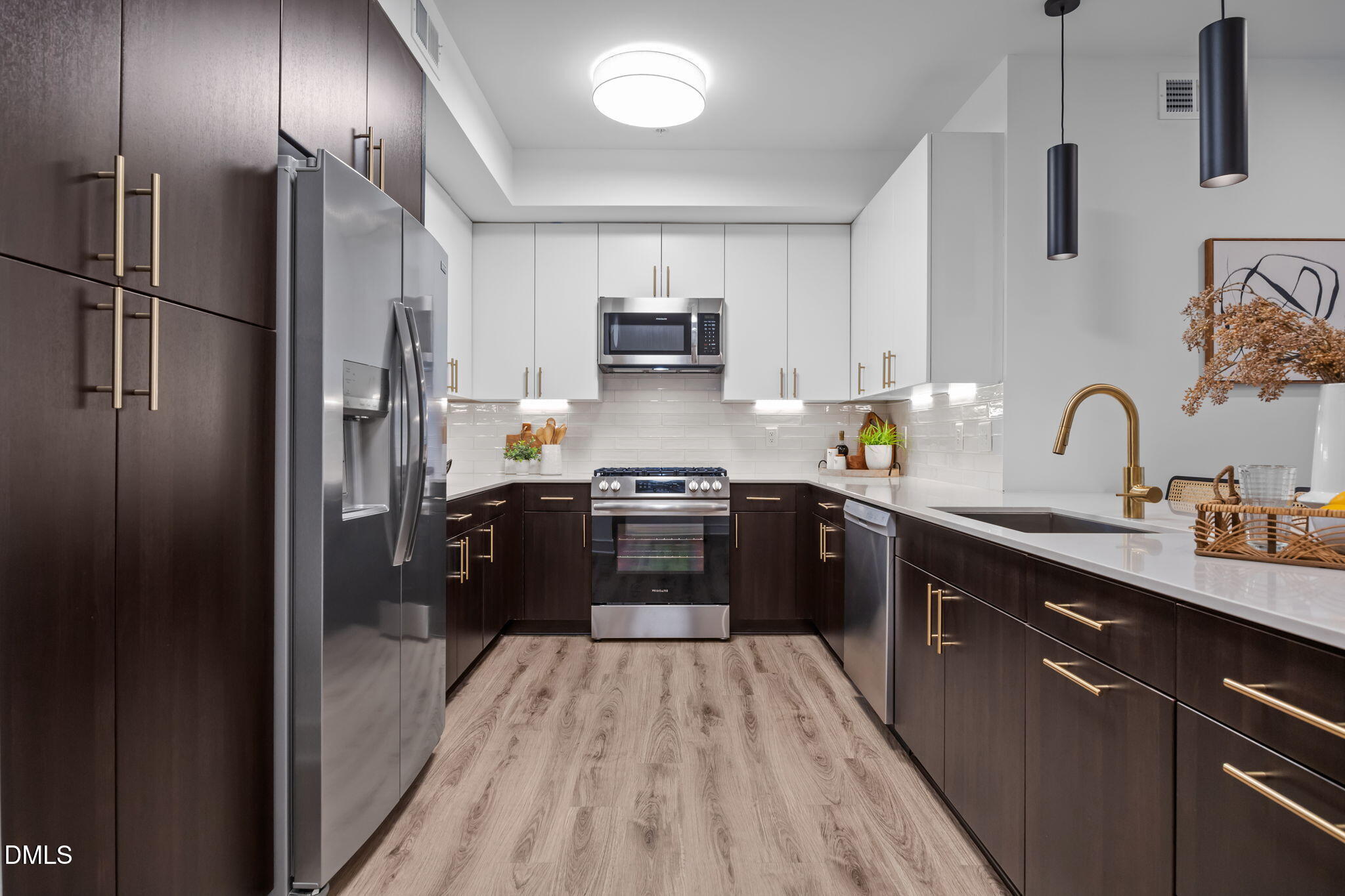 a kitchen with a refrigerator sink and wooden cabinets