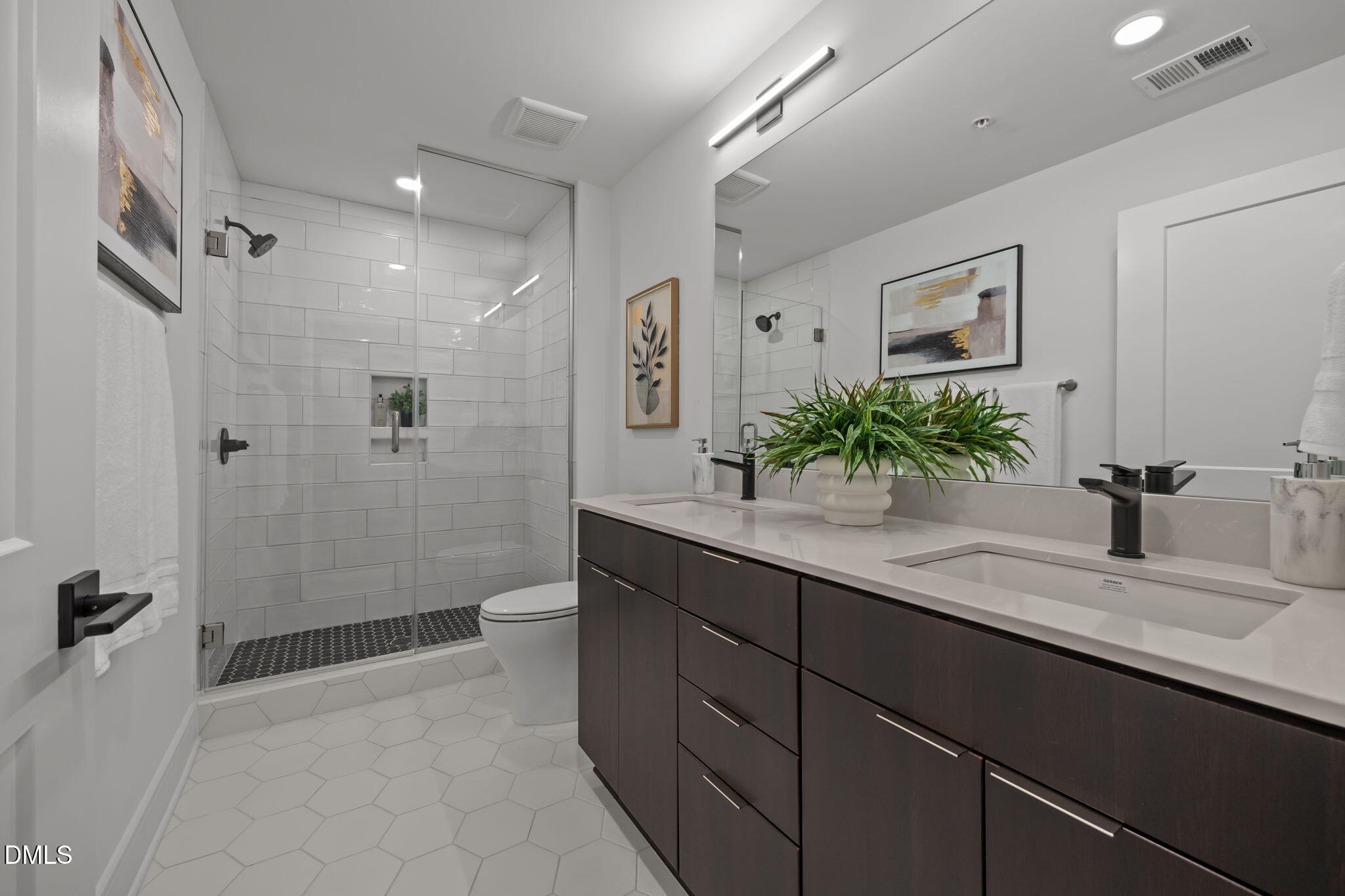 615 West Peace Street, Unit 202 Raleigh, NC 27603 - Photo 17 of 24 a bathroom with a granite countertop sink a toilet a large mirror and shower