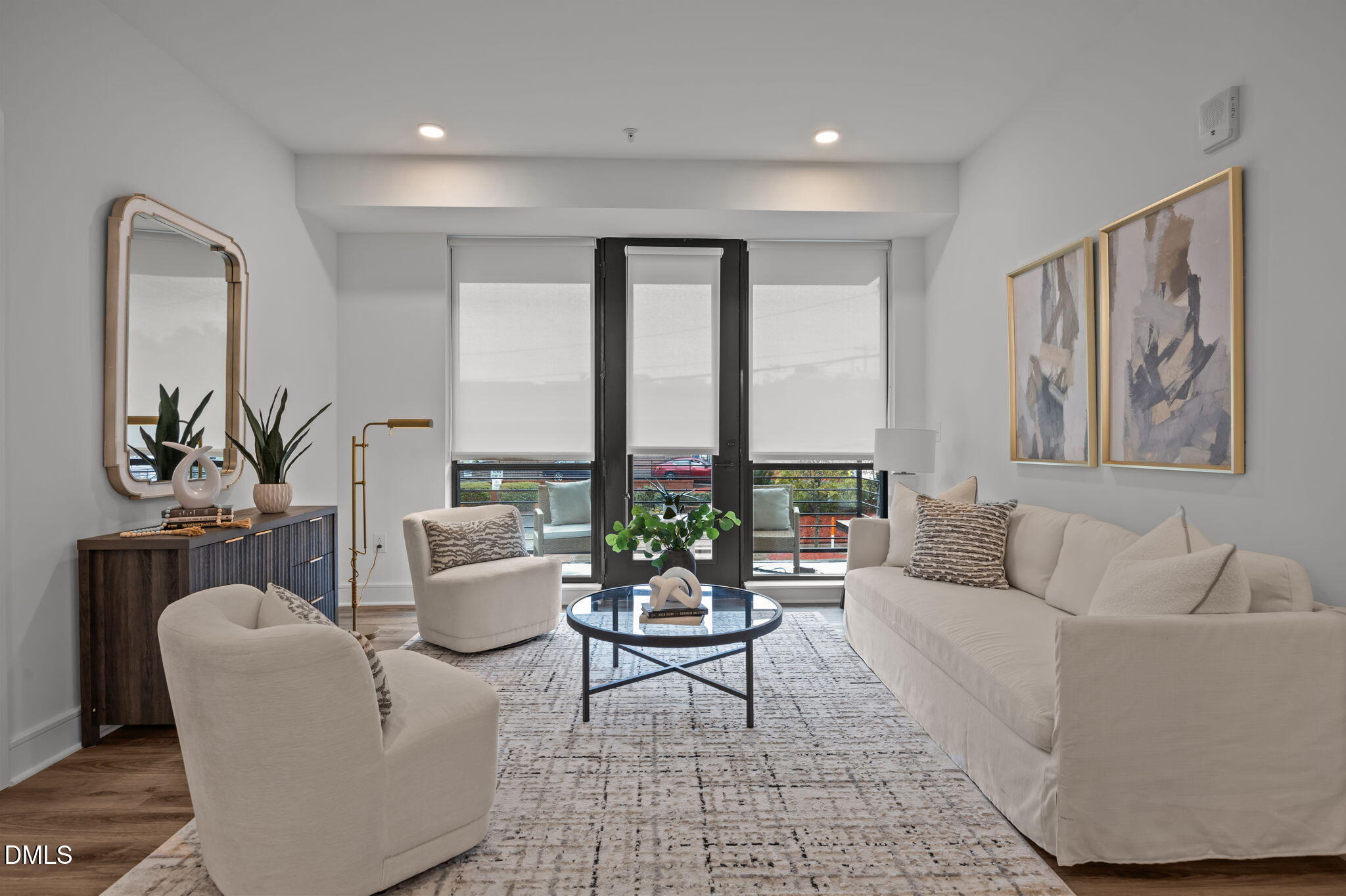 615 West Peace Street, Unit 202 Raleigh, NC 27603 - Photo 3 of 24 a living room with furniture and floor to ceiling windows