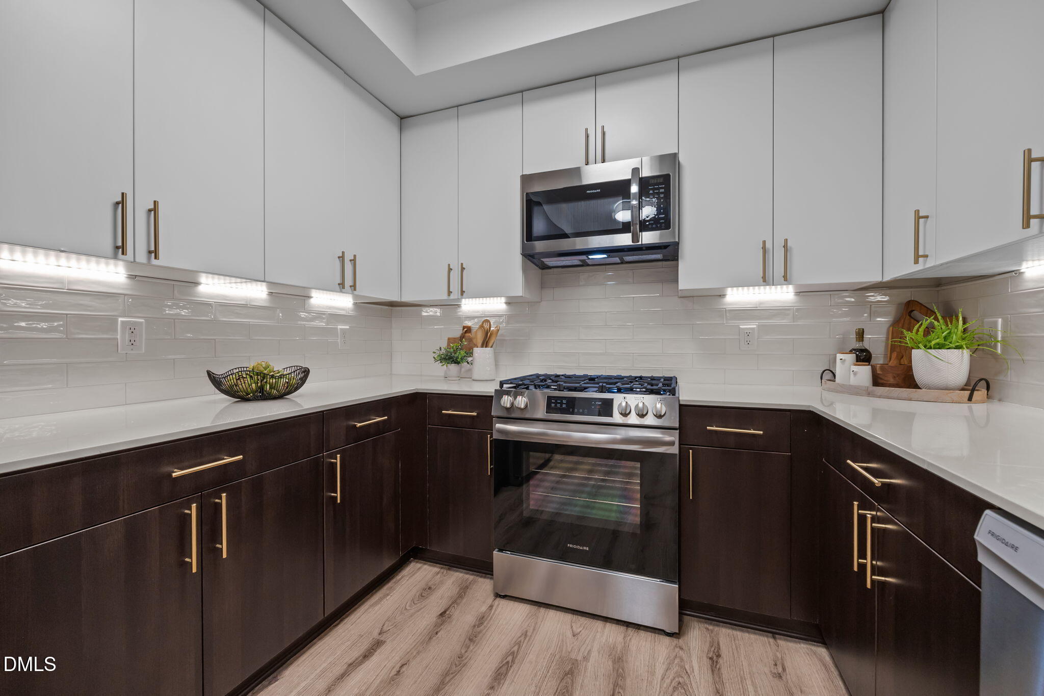 615 West Peace Street, Unit 202 Raleigh, NC 27603 - Photo 4 of 24 a kitchen with kitchen island granite countertop a sink a stove and cabinets