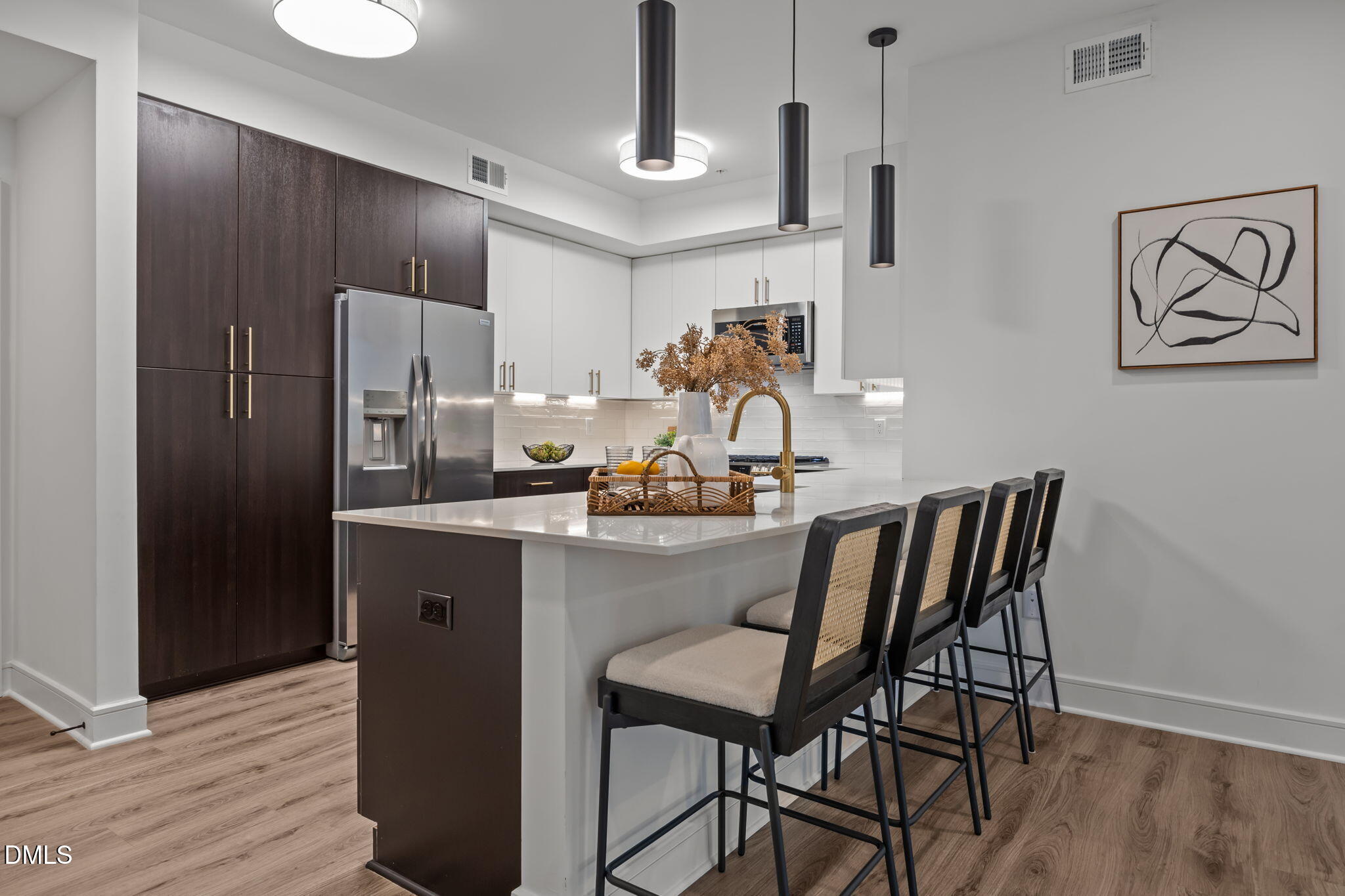 615 West Peace Street, Unit 202 Raleigh, NC 27603 - Photo 6 of 24 a kitchen with stainless steel appliances a dining table chairs and wooden floor