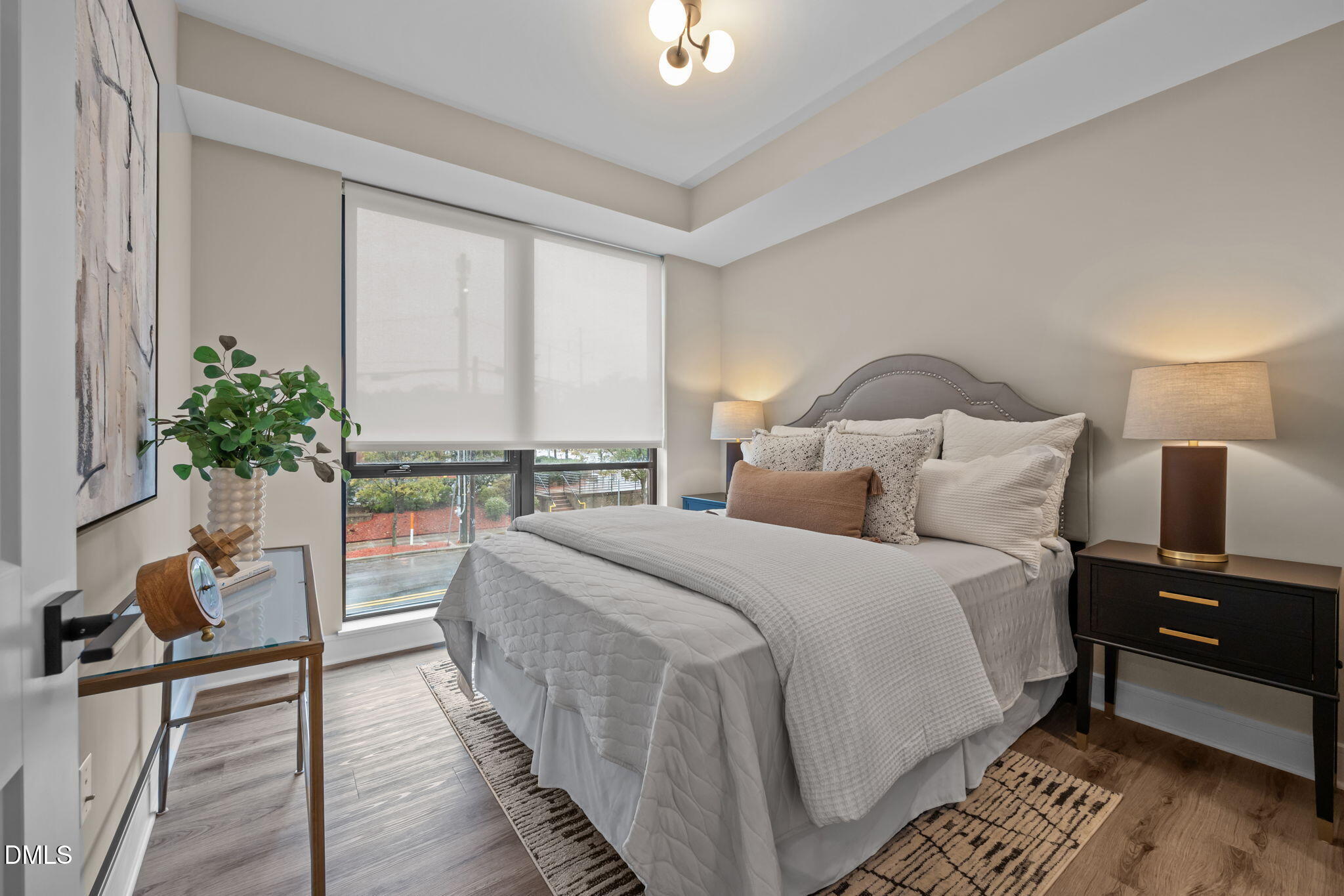 615 West Peace Street, Unit 202 Raleigh, NC 27603 - Photo 9 of 24 a bed room with a bed and a potted plant